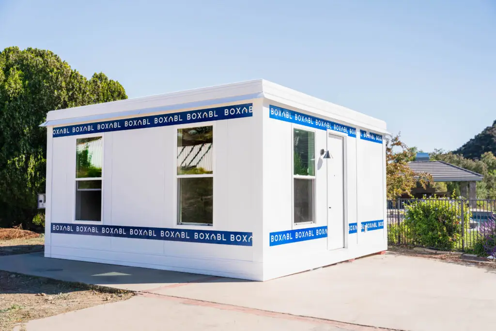 Boxabl modular home featuring a modern design, prominently displaying "BOXABL" branding, set in a sunny outdoor environment suitable for San Diego County living.