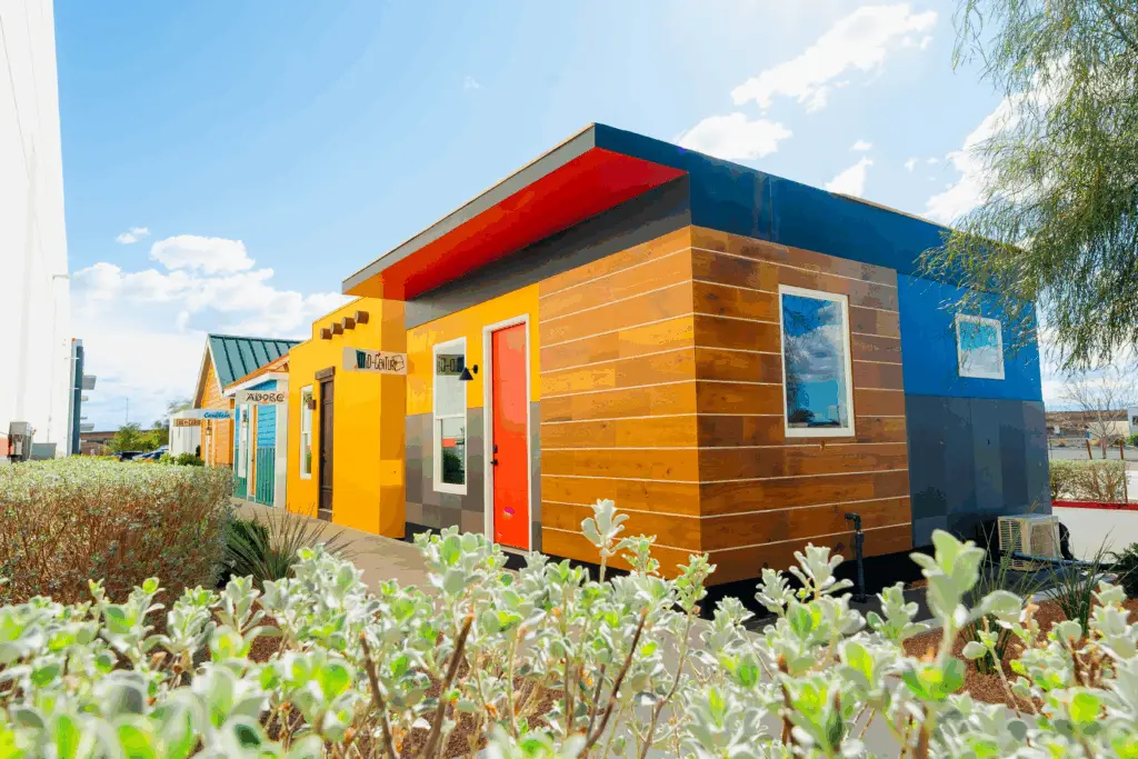 Colorful modular home showcasing modern design with clean lines, integrated into a landscaped setting, reflecting Boxabl's commitment to sustainable construction and contemporary aesthetics suitable for San Diego.
