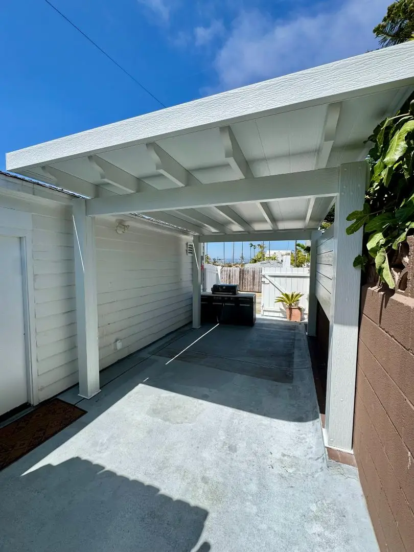 Custom insulated patio cover installation in Lakeside, CA, featuring a sleek design, integrated LED ceiling lights, and comfortable outdoor space.